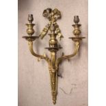 A BRASS WALL LIGHT WITH 3 LIGHT BRANCHES, decorated with a large flowing ribbon bow and reeeded body