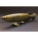 A BRASS ORNAMENT IN THE FORM OF A FISH, 11" x 2" x 3.75" approx