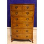 A MAPLE WOOD BOW FRONTED 'TALL BOY' CHEST, with 2 over 5 drawers, each with brass handles, raised on