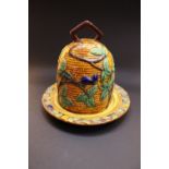 A MAJOLICA STYLE CHEESE DOME, with basket weave design, and berry & leaf decoration, 6.5" tall and
