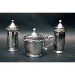 AN IRISH SILVER CONDIMENT SET, includes; (i) Salt Shaker, (ii) Pepper Shaker, (iii) a Mustard