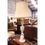 AN ALABASTER CARVED TABLE LAMP, with shade, in need of a little restoration, 29" tall approx (