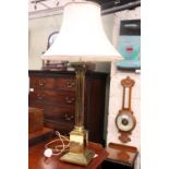 A BRASS CORINTHIAN STYLE TABLE LAMP, with shade