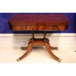 A VERY FINE REGENCY FOLD OVER CARD TABLE, with canted corners raised on 4 turned supports, sitting