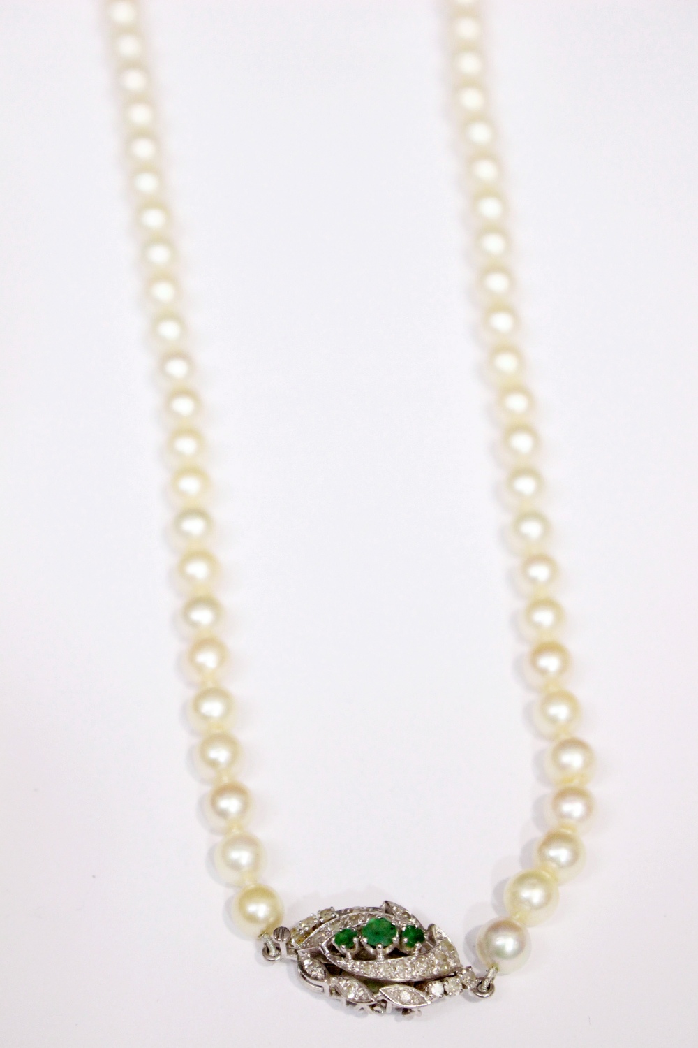 A FRENCH PEARL NECKLACE, with platinum and gold clasp, encrusted with diamonds and 3 emeralds - Image 2 of 2