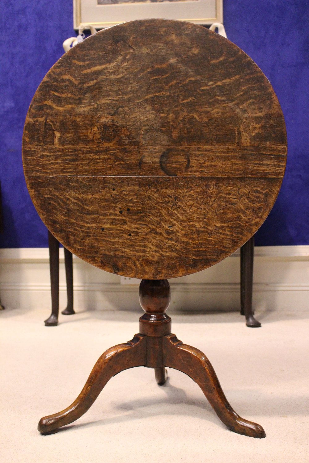 AN 18TH CENTURY TIP UP CENTRE TABLE, with oak top and fruit wood base, a column support on a