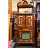A MUSIC CABINET, decorated all over with inlaid detail, a raised mirror backed gallery to the top,