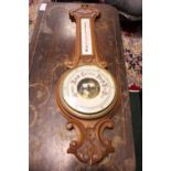 A CARVED ANEROID BAROMETER, in need of restoration, 31.5" x 10" approx
