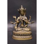A BRASS FIGURE OF THE BUDDHIST DIETY USHNISHAVIJAYA, with three heads and 8 arms, sitting in the