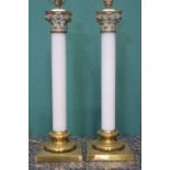 A PAIR OF FRENCH ORMOLU-MOUNTED OPALINE GLASS TABLE LAMPS, in the form of Corinthian columns, 24”