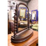 A MAHOGANY "SWING" DRESSING MIRROR, table top, with turned upright supports, and demi lune