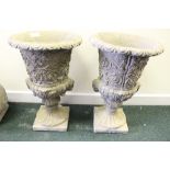 A PAIR OF GEORGIAN STYLE GARDEN URNS, with floral design, standing on plinths, 24" tall approx