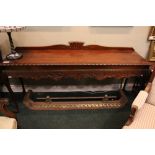 A LARGE SERVING TABLE / SIDE BOARD, with carved skirt, having foliage and crosshatch detailing,