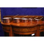 A SET OF 5 COPPER SAUCEPANS, with brass handles