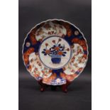 AN IMARI PLATE, with scalloped rim, and central vase with flowers & gold highlight design, and