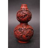 A CINIBAR DOUBLE GOURD SHAPED VASE, with red lacquer colour, floral panels, 6" tall 3" wide, with