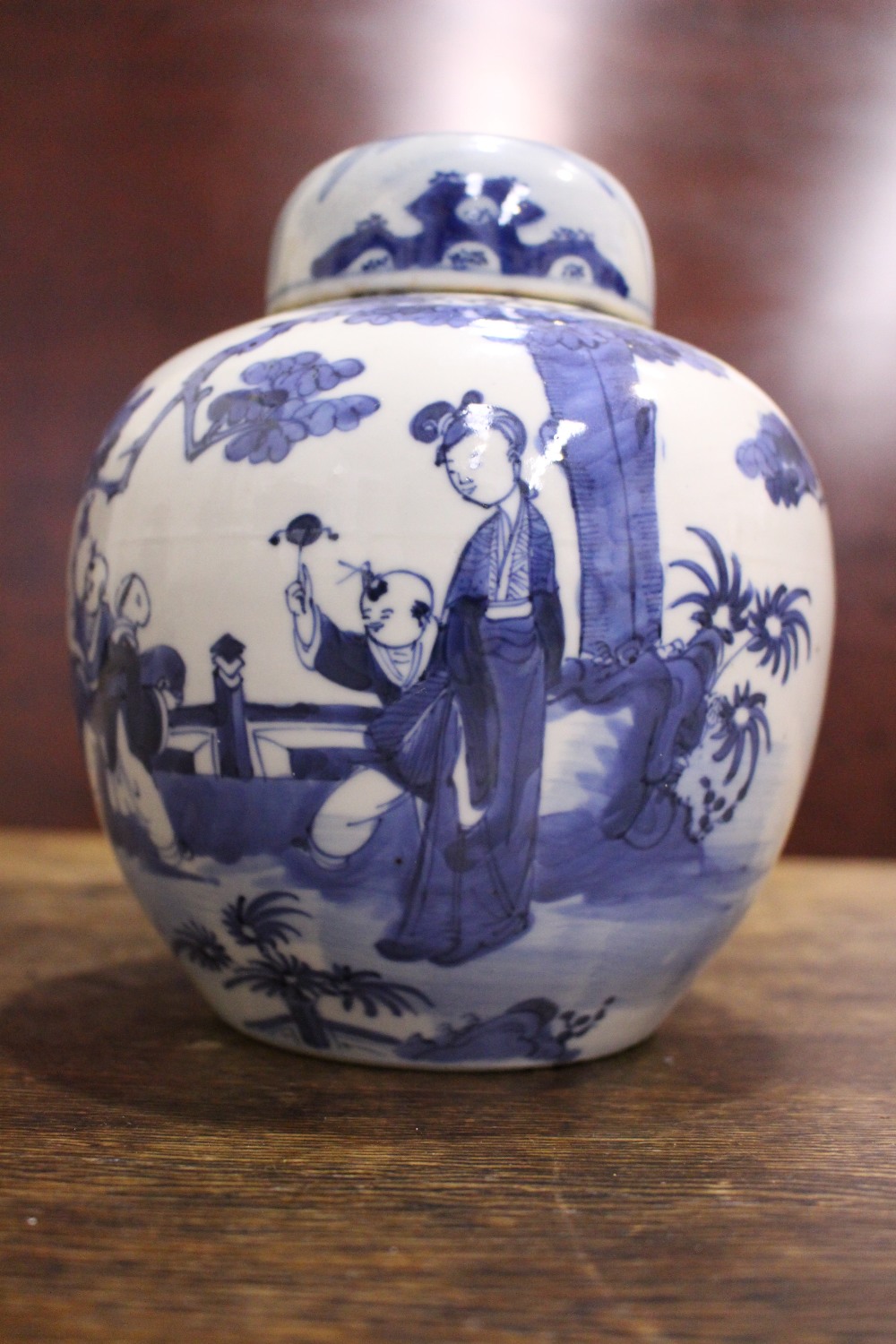 A BLUE & WHITE GINGER JAR with lid, decorated with images of children and a woman playing in a - Image 2 of 7