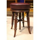 A LATE 19TH CENTURY ADJUSTABLE PIANO / DRESSING STOOL, raised on four turned and reeded legs, with