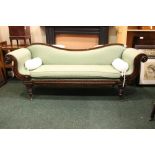 A LARGE VICTORIAN SERPENTINE BACKED COUCH, with roll over scroll ending arm rests, raised on