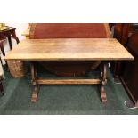 ÀN OAK TRESTLE DINING TABLE / KITCHEN TABLE, raised on a pair of shaped pierced side supports,