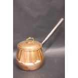 A COPPERWARE POT, with lid and cast iron handle, provenance came from the Bryan & Valarie Steele