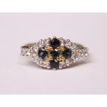 A 9CT YELLOW GOLD RING, with sapphire blue and clear stone setting