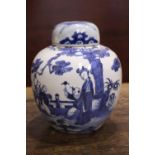 A BLUE & WHITE GINGER JAR with lid, decorated with images of children and a woman playing in a