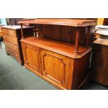 A MAHOGANY SIDE BOARD, with raised shelf on fluted turned supports, over 2 door cabinet, with