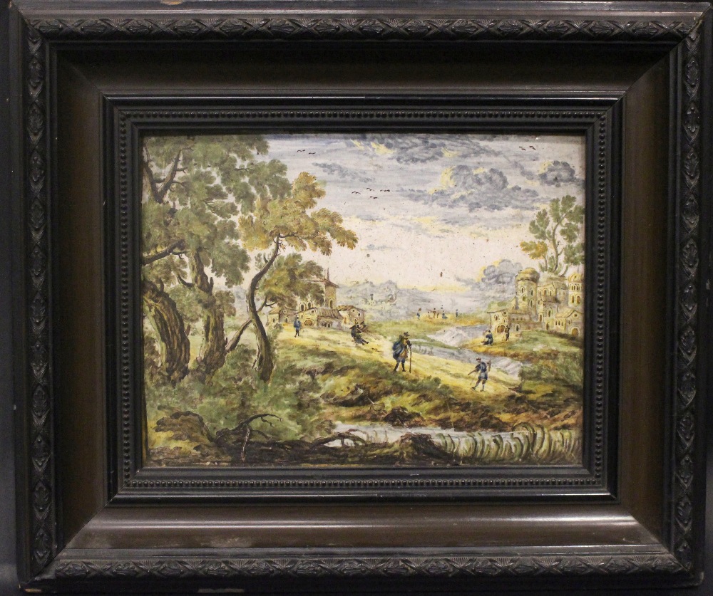 A FRAMED ‘CASTELLI’ LANDSCAPE TILE WITH FIGURES AND BUILDINGS, possibly 18th century, inscribed