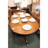 A TWO POD EXTENDABLE MAHOGANY DINING TABLE, with reeded rim, with turned column supports, and tripod