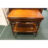 AN EARLY 20TH CENTURY FOLD OVER CARD TABLE, raised on turned supports, united by lower shelf,