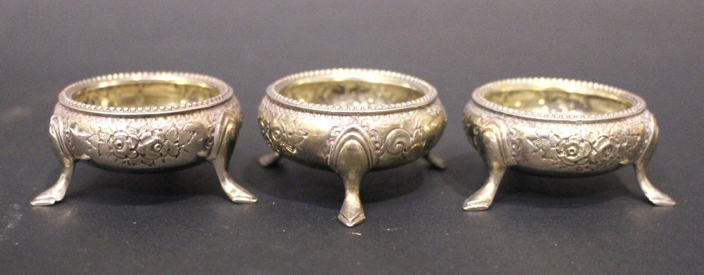 A SET OF 3 19TH CENTURY SALT CELLARS / CAULDRONS, each decorated with floral embossed design, and