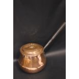 A COPPERWARE POT, with lid, and cast iron handle, 8" tall, 10" length of handle, provenance came