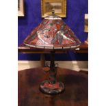 A TIFFANY STYLE TABLE LAMP, with dragon fly shade in red colours, with a two toned graduating column