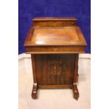 A VERY FINE ROSEWOOD INLAID DAVENPORT, with lift up leather topped writing slope, a raised back with