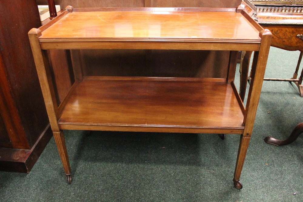 A TWO TIER WHAT NOT / SERVING TABLE, with reeded tapering legs on castors, 36" x 18" x 32.5" approx