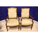 A FINE PAIR OF REGENCY STYLE BRASS INLAID LIBRARY CHAIRS, with scroll tipped arm rests, raised on