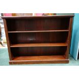 A MAHOGANY FLOOR STANDING BOOKCASE, with two adjustable shelves, on a platform base