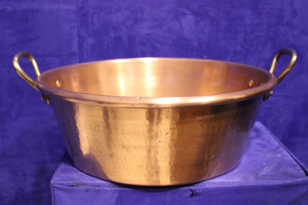 A LARGE COPPER 'PRESERVING' POT / 'JAM' POT, with a pair of brass handles, 19" including handles,