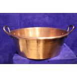 A LARGE COPPER 'PRESERVING' POT / 'JAM' POT, with a pair of brass handles, 19" including handles,