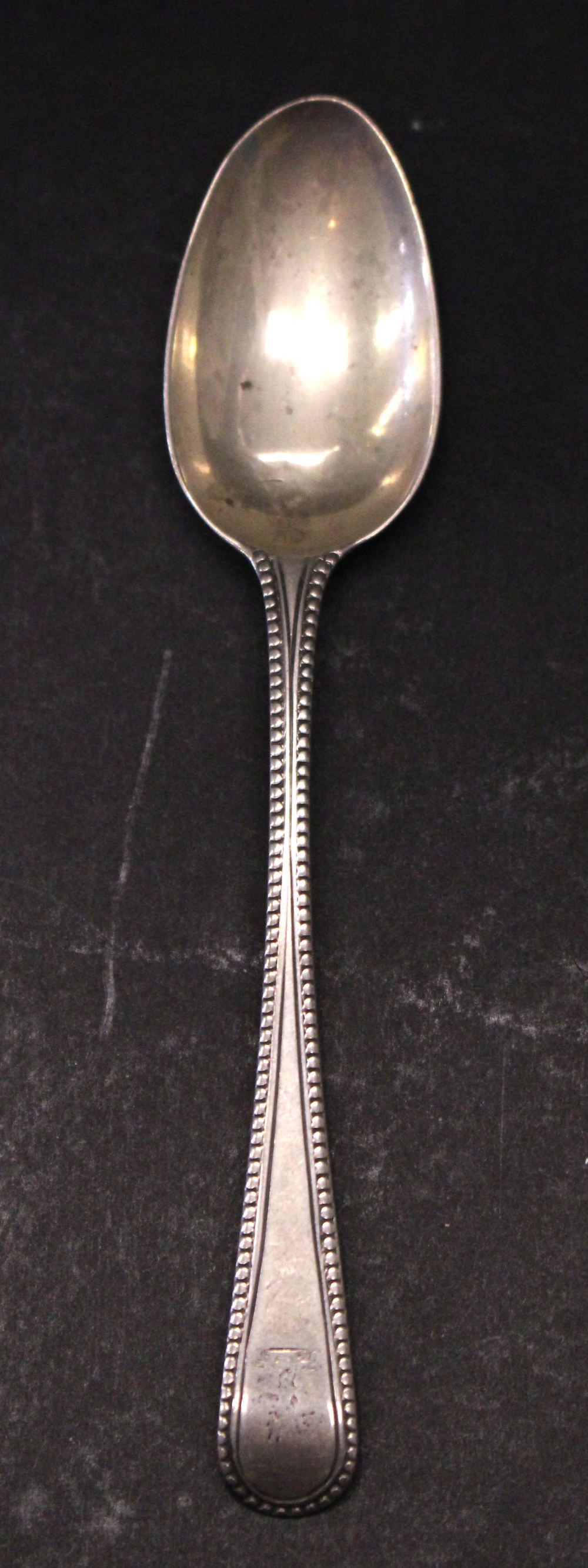 A GEORGIAN SILVER TEASPOON, possibly London, 1822, maker’s mark indistinct, with beaded detail to