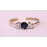 AN 18CT SAPPHIRE & DIAMOND three stone ring