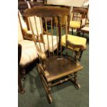 A LOW RISE ROCKING CHAIR, with turned stretcher, and spindle back, 40" x 24" x 29" approx
