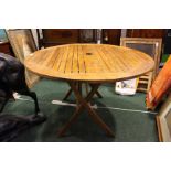 A LARGE CIRCULAR TEAK GARDEN TABLE, collapsible