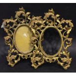 A PAIR OF GILT METAL PICTURE FRAMES, omolu Style, with intertwined foliage design, one with glass,