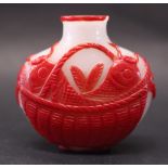 A RED OVERLAY SNUFF BOTTLE, with imagery displaying a basket with Koi fish on both front & back,
