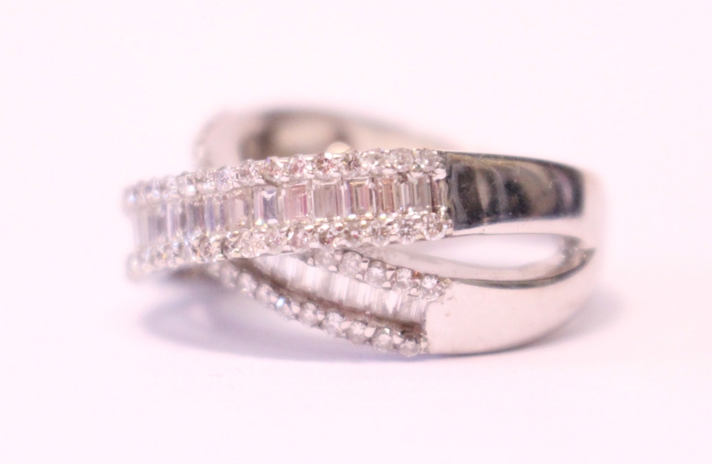 AN 18CT WHITE GOLD DIAMOND CROSS OVER RING, with baguette and round brilliant cut diamonds, 2.10cts - Image 2 of 3