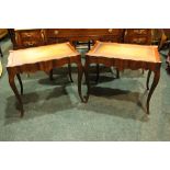 A PAIR OF SERPENTINE SHAPED LEATHER TOPPED TABLES, raised on cabriole shaped legs 26" x 19" x 22"