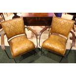 A PAIR OF CONTEMPORTY LEATHER ARMCHAIRS, with metal frames and curved wooden arm rests