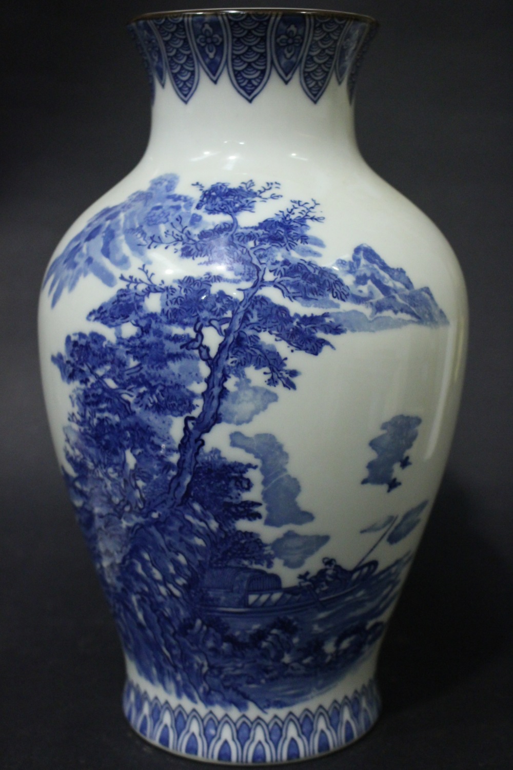 A JAPANESE BALUSTER SHAPED VASE, with blue & white colouring, having a large image of a wooded